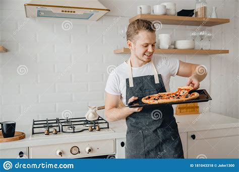 chef pizza italian homemade apron holds handsome baking bright sheet cooking male young dark kitchen concept