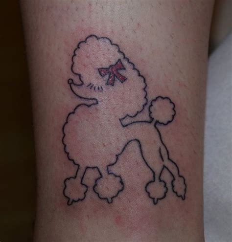 A Tattoo On The Leg Of A Person With A Poodle In Its Hair