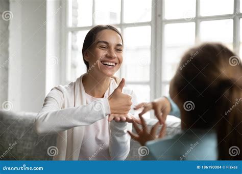 Smiling Caucasian Woman Learn Sign Language With Little Kid Stock Photo