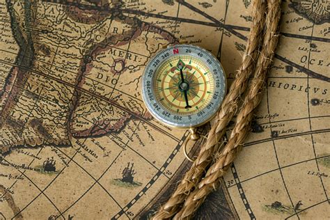 Old Compass On Vintage Map With Rope Mike Bonem