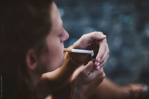 Woman Smoking A Cigarette By Stocksy Contributor Mauro Grigollo