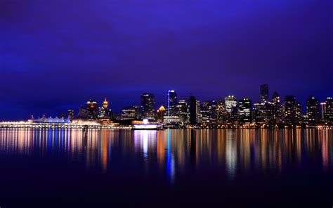 City Skyline With Reflection Of Water During Nighttime Hd Wallpaper