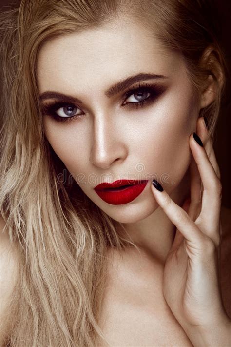 beautiful blonde girl with sensual lips fashion hair black art nails beauty face stock image