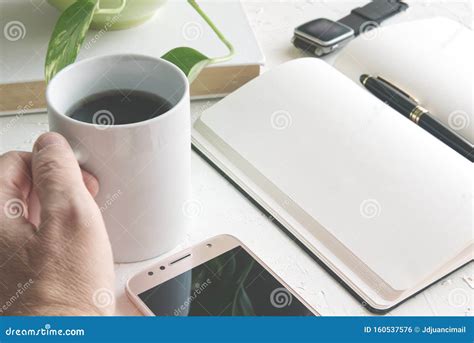 Hand Writing With A Pen On A Paper Notebook Next A Book And A Mug With