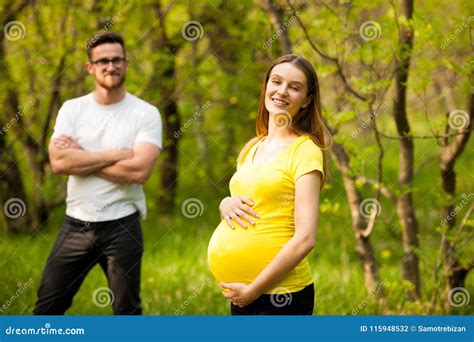 Mujer Embarazada Con Su Hombre Par Feliz En Parque Foto De Archivo