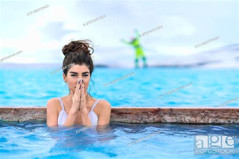 Delightful Girl In A White Swimsuit Relaxing In The Geothermal Pool On
