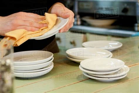 Hands Drying Dishes In Kitchen Stock Photo Dissolve