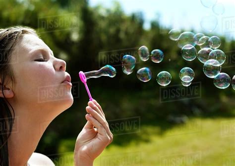 Girl Blowing Bubbles Outdoors Stock Photo Dissolve