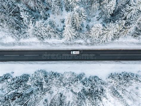 Aerial View Of Winter Road And Forest With Snow Covered Trees In