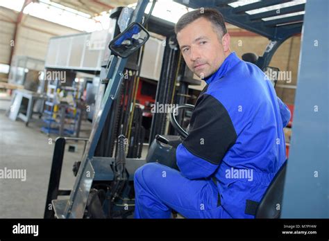 man driving a warehouse vehicle Stock Photo - Alamy
