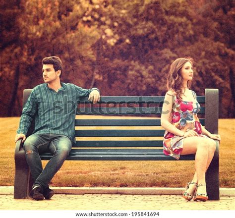 Young Couple Sitting Apart On Bench Stock Photo 195841694 Shutterstock