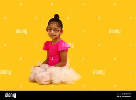 4 Year Old Brunette Latina Girl With Eyeglasses Dressed In Pink Leotard