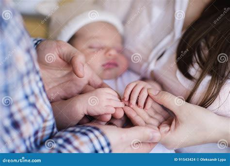 Mother And Father Holding Hand Of Sleeping Baby Stock Photo Image Of