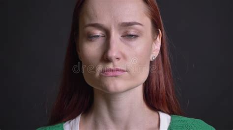 Closeup Of Attractive Female Face With Blue Eyes Looking Straight At Camera With Neutral Serious