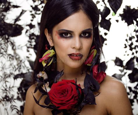 Pretty Brunette Woman With Rose Jewelry Black And Red Bright Make Up Like A Vampire Closeup
