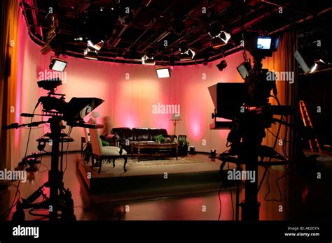 Television Production Studio And Cameras With A Colorful Lit Set Design