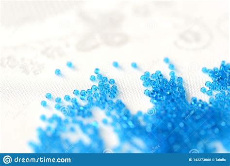 Transparent Seed Beads Blue Color Scattered On A Textile Background