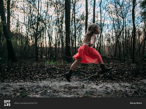 Little Girl Running Through The Woods Stock Photo Offset