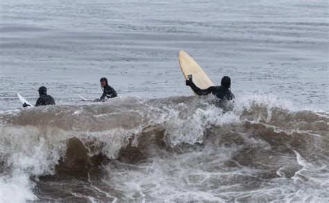 Surfers Take On An Icy Lake Superior Amid Winter Storms