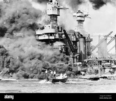 pearl harbor 1941 a small boat rescuing a seaman from the uss west virginia burning in the