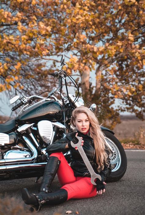 Beautiful Biker Woman Posing With Motorcycle Outdoors Stock Image