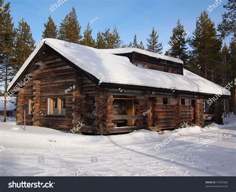 Snow Covered Log Cabin In A Holiday Resort In Yllas
