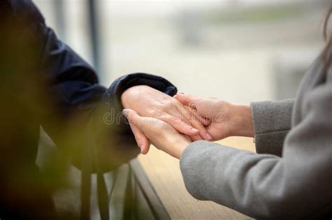 Close Up Of Young Female Hands Holding Senior Woman Hands Stock Image