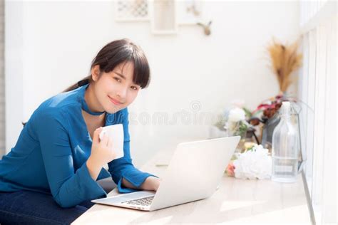 Beautiful Young Freelance Asian Woman Smiling Working And On Laptop