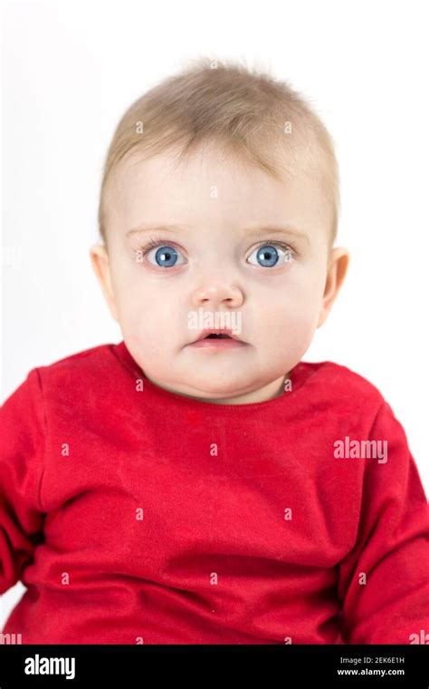 A Child With Wide Open Eyes Looks Directly White Background Stock Photo