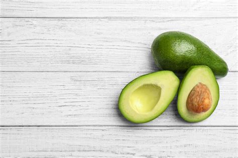 Tasty Ripe Green Avocados On Wooden Background Stock Photo Image Of