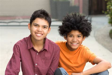 Young Mixed Race Teenage Brothers Looking At The Camera Stock Photo