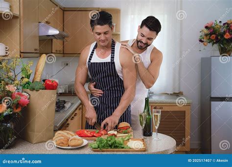 Caucasian Lgbtq Gay Couple Enjoying Cooking Food Together In Kitchen Stock Image Image Of