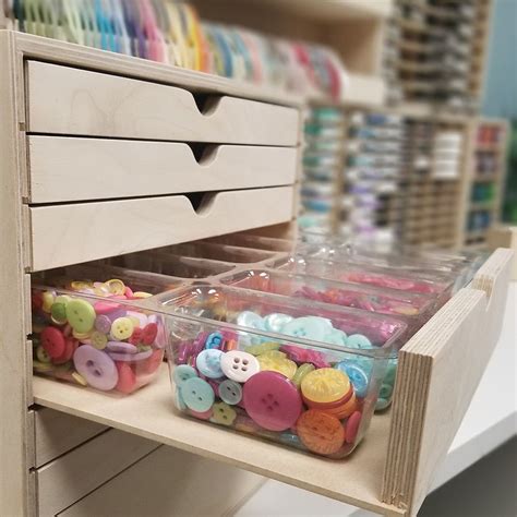 The Drawers Are Filled With Buttons And Other Crafting Supplies In