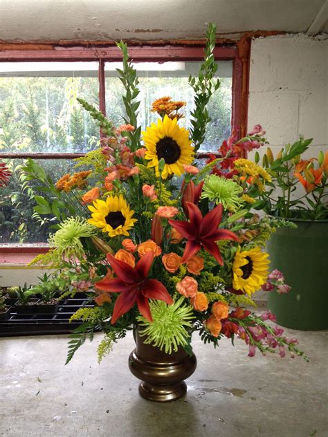 A Beautiful Funeral Arrangement Using Lilies And Sunflowers Arreglos