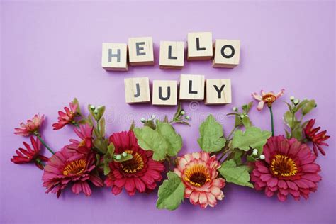 Hello July Alphabet Letters With Pink Flower Decoration On Purple