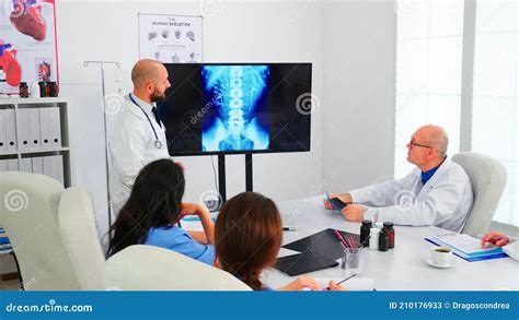 Group Of Doctors Listening Medical Expert During Medical Conference