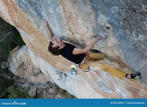 Rock Climber Ascending A Challenging Cliff Extreme Sport Climbing