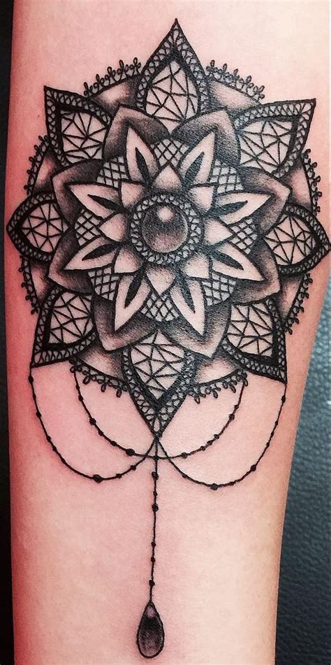 A Black And White Tattoo Design On The Leg With An Intricate Flower In