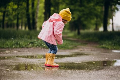 Free Photo Cute Little Girl Jumping Into Puddle In A Rainy Weather