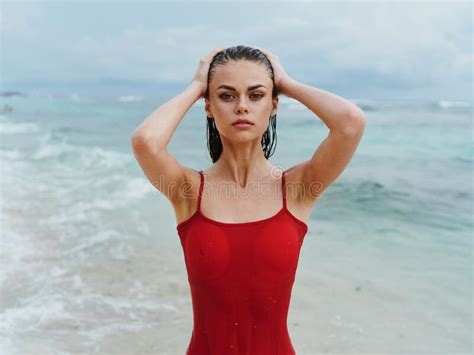 Beautiful Woman In A Red Swimsuit On The Ocean Beach With Wet Hair Tan Stock Image Image Of