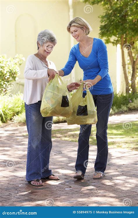 Woman Helping Senior Female With Shopping Stock Image Image Of Bags