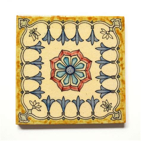 A Ceramic Tile With An Ornate Design On It