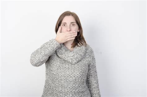 Girl Wearing Winter Clothes And Her Hand In Her Mouth Stock Image