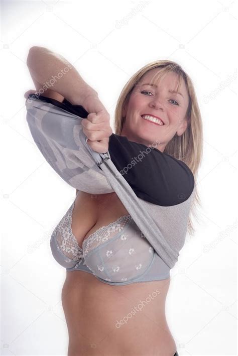 Woman Removing Her Sweater To Reveal Her Bra Stock Photo By Petertt
