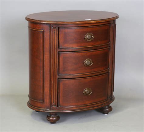A Modern Reproduction Mahogany Oval Chest Of Three Drawers Height 70cm Width 68cm Depth 46cm