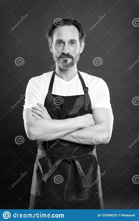 Confident In His Culinary Craft Cook With Beard And Mustache Wearing Apron Red Background Man