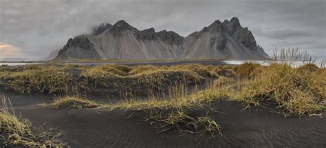 Black Volcanic Sand Dunes On The Beach At Stokness Iceland By Sergey