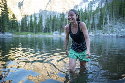 Young Woman Wading Through Lake The Enchantments Alpine Lakes