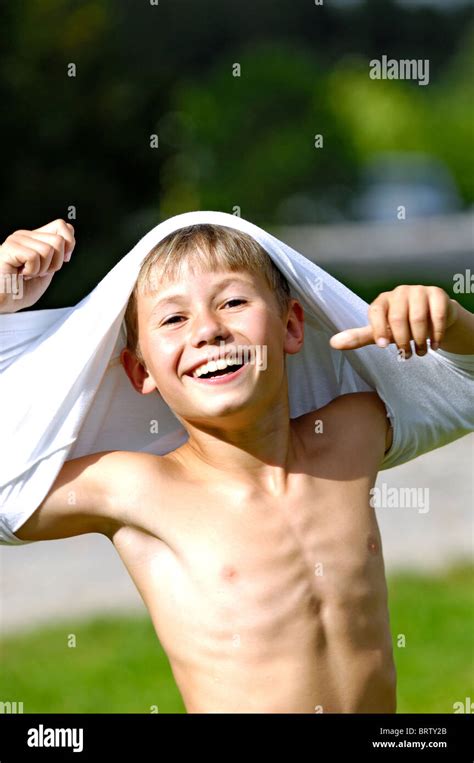 Smiling Boy Undressing The Shirt Stock Photo Alamy