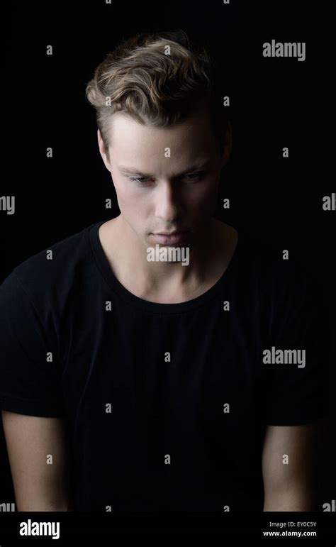 A Blond Handsome Caucasian Man Sitting With Face Looking Down He